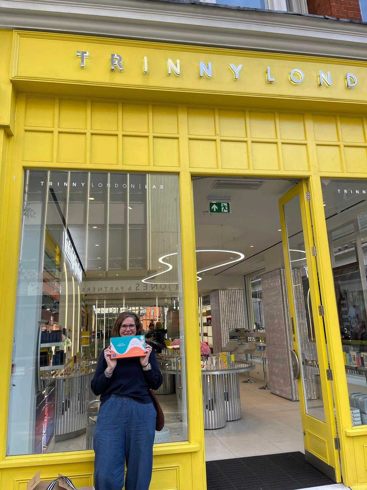 Carla outside the Trinny London flagship store on King’s Road, Chelsea, holding a boxed Good Wash Day hair towel