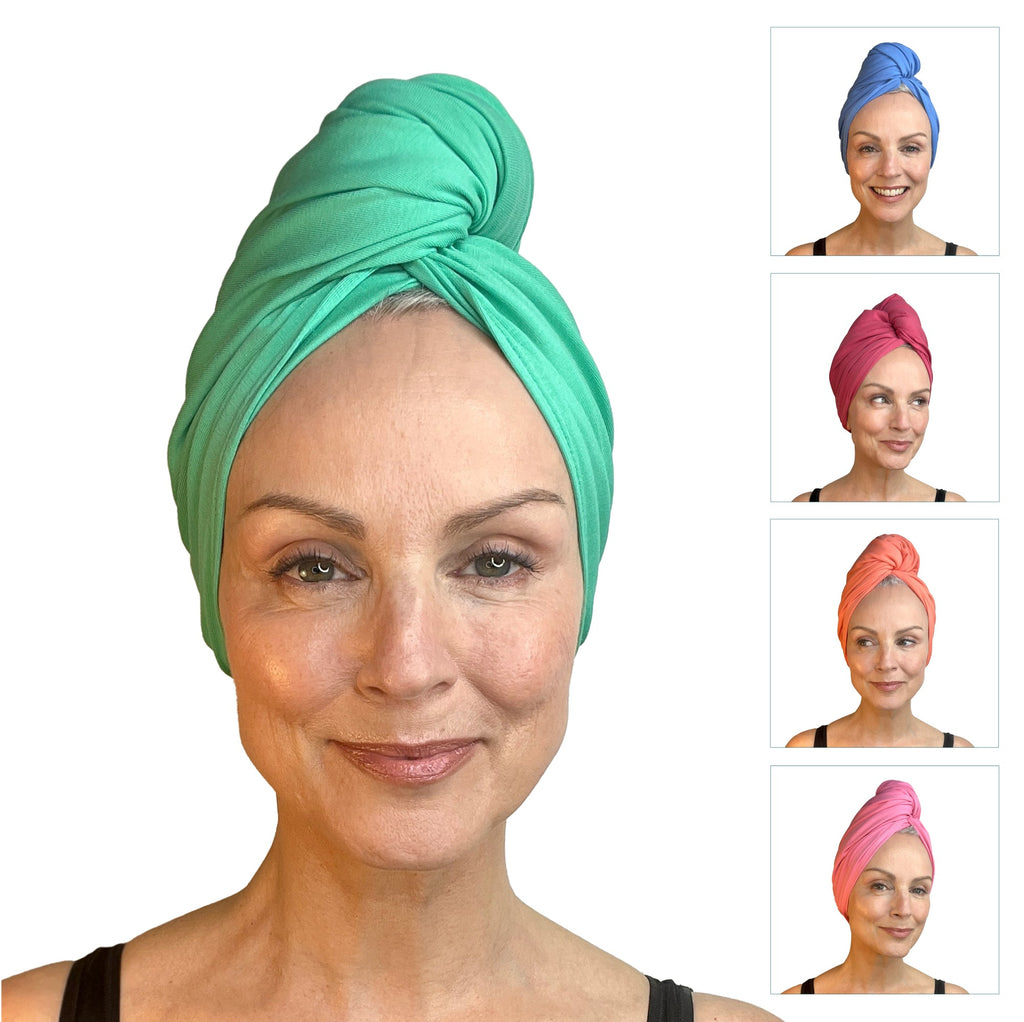 A woman showcasing Good Wash Day's The Pastels head wraps in various colors.