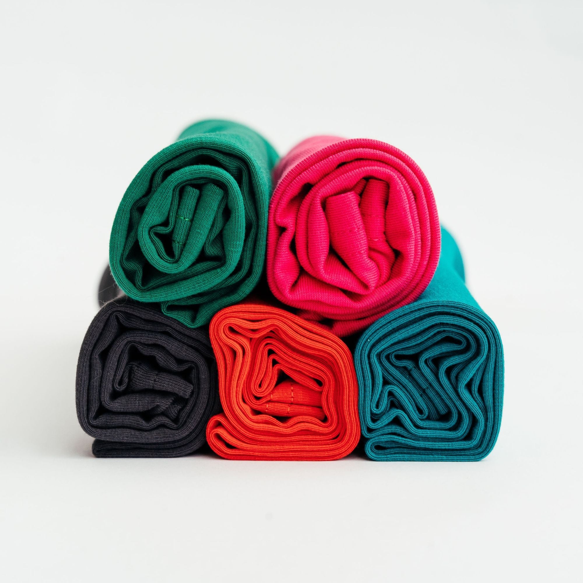 Five rolled organic jersey cotton hair towels in bright colours