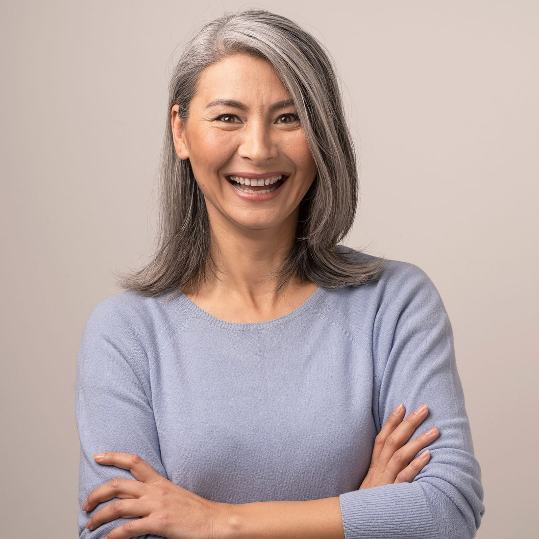 Woman with healthy silver grey hair smiling – Good Wash Day guide to looking after silver hair
