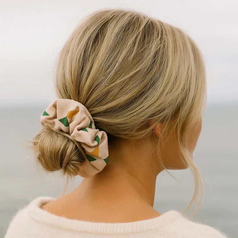 Lady with blonde hair pulled back into a low bun