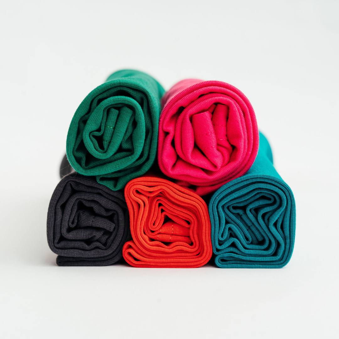 Five rolled organic jersey cotton hair towels in bright colours
