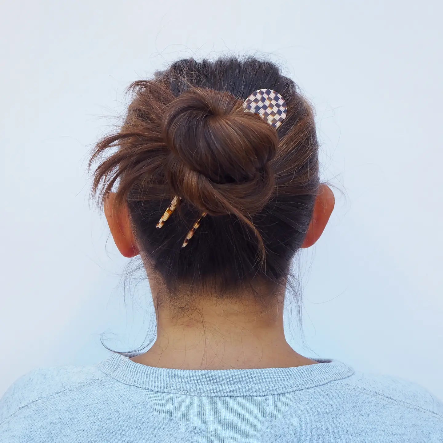 Woman with hair in a French hair pin with checkered design - Anna Butler
