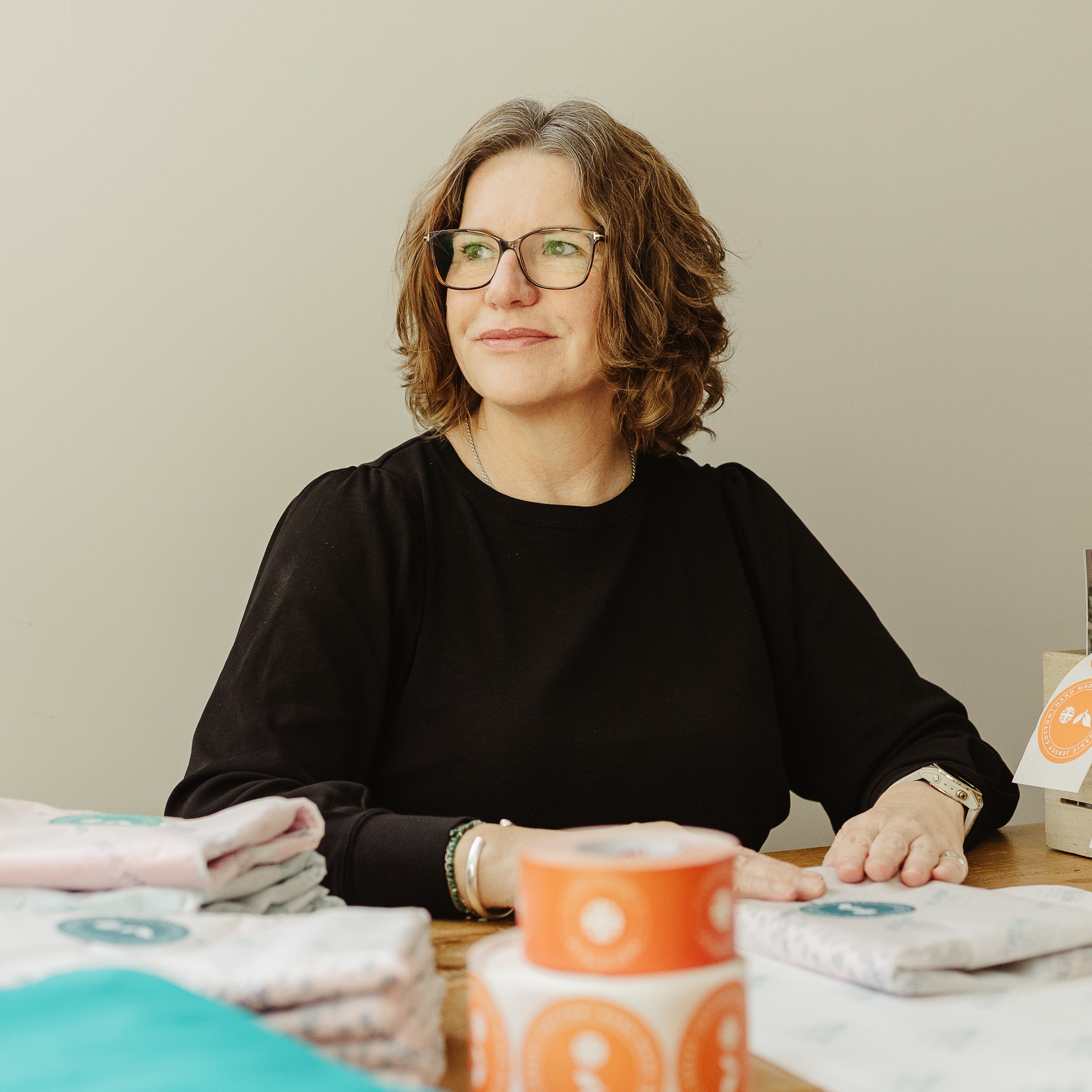 Carla, founder of Good Wash Day, at her workspace with organic jersey cotton hair towels