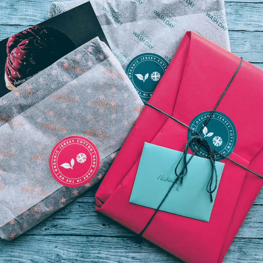 Pink Good Wash Day sustainable gift wrap with branded sticker