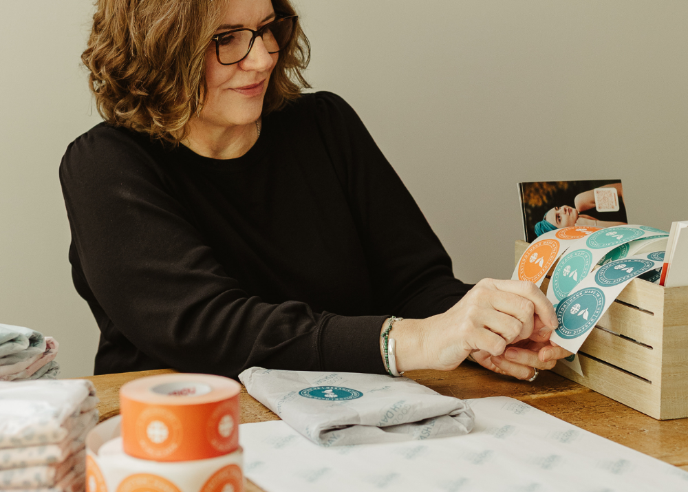 Good Wash Day hair towel being wrapped with eco-conscious packaging and branded stickers