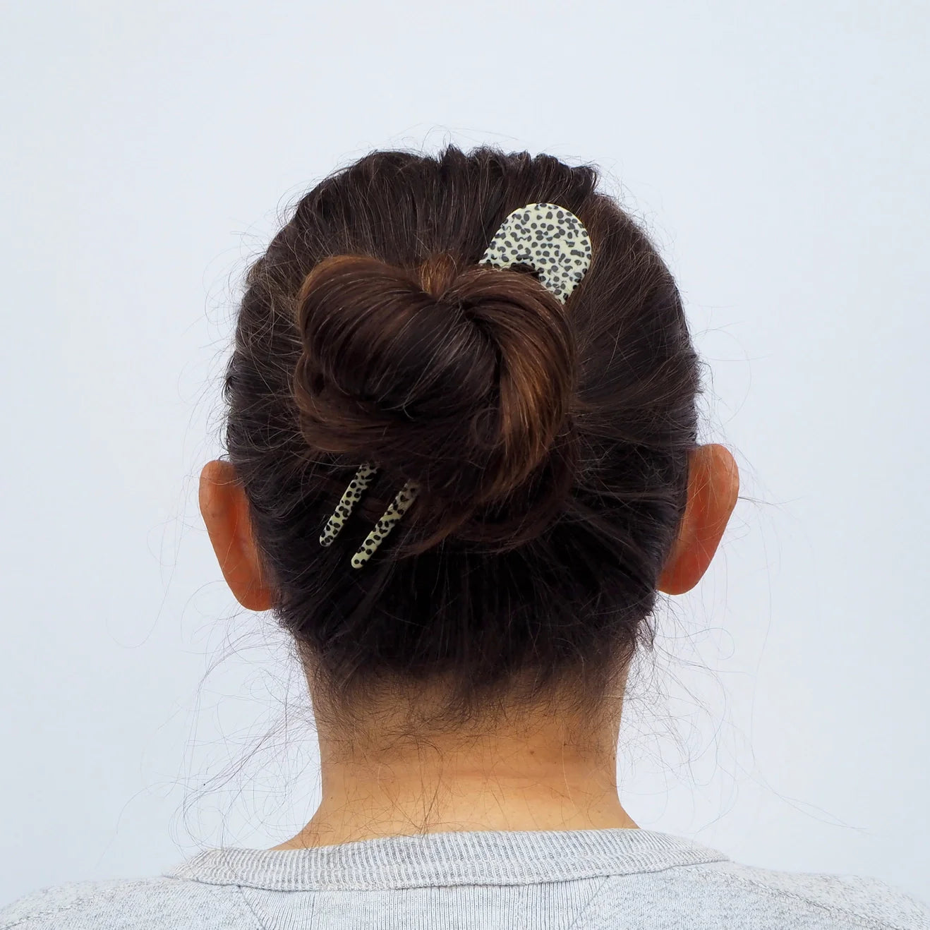 Woman wearing animal print French style hair pin to secure her long hair - Anna Butler