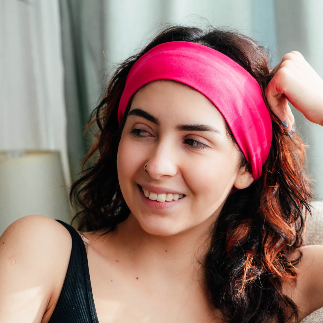 Woman with long wavy hair wearing hot pink organic jersey cotton headband – Good Wash Day