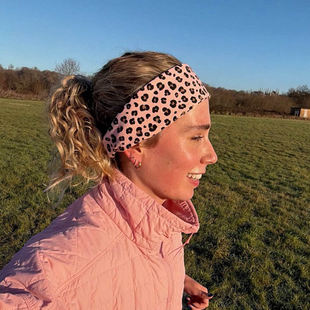Woman wearing pink leopard print organic jersey cotton headband whilst jogging outdoors  – Good Wash Day