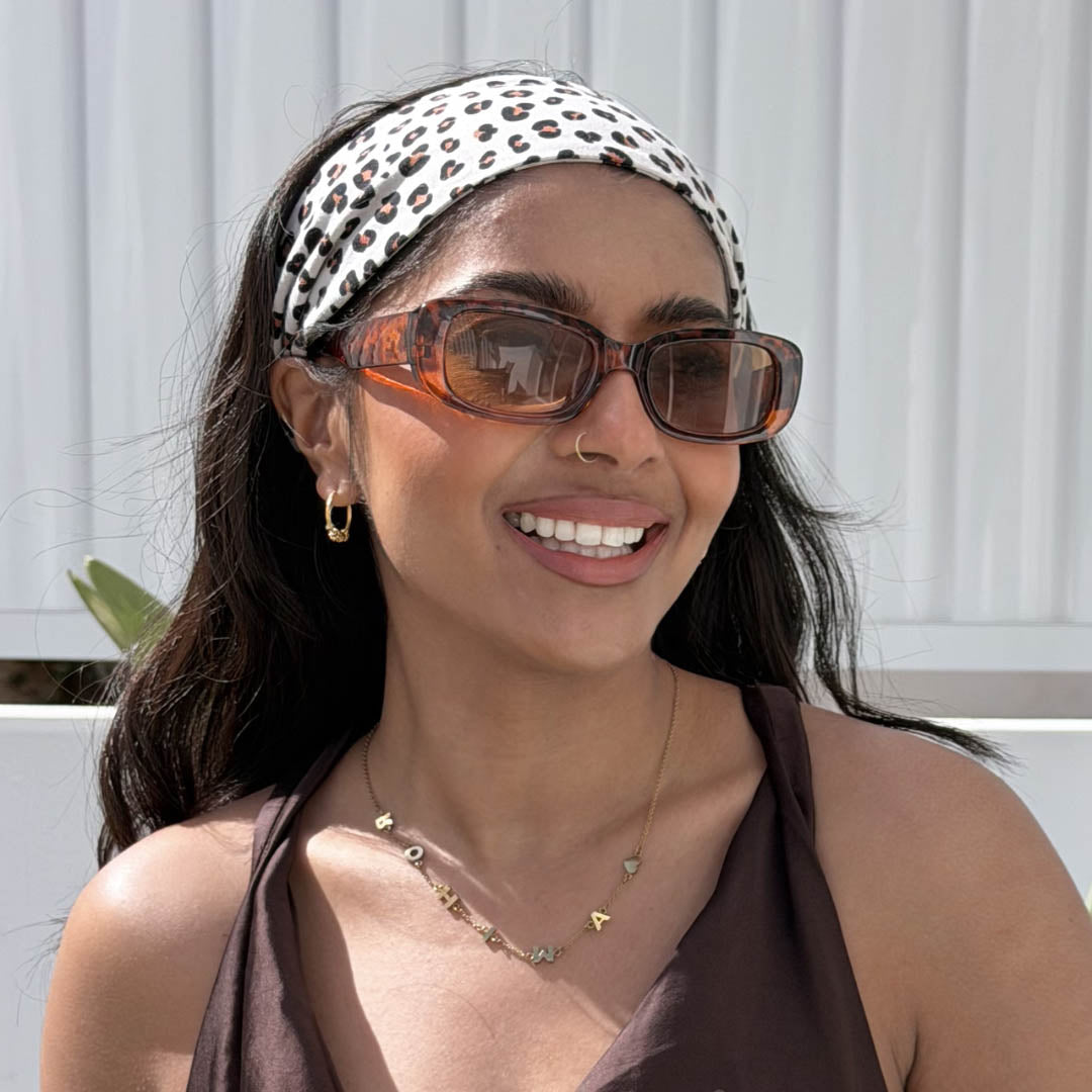 Woman wearing cream  leopard print organic jersey cotton headband and sunglasses – Good Wash Day