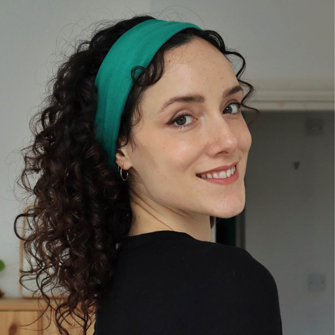 Woman with dark curly hair wearing teal organic jersey cotton headband – Good Wash Day