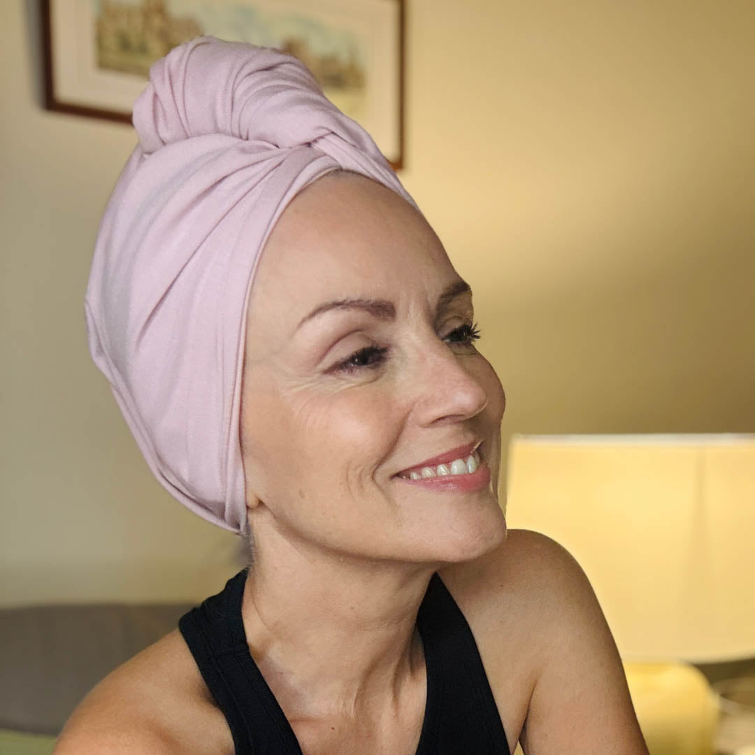 Woman wearing blush pink organic jersey cotton hair towel wrap – Good Wash Day