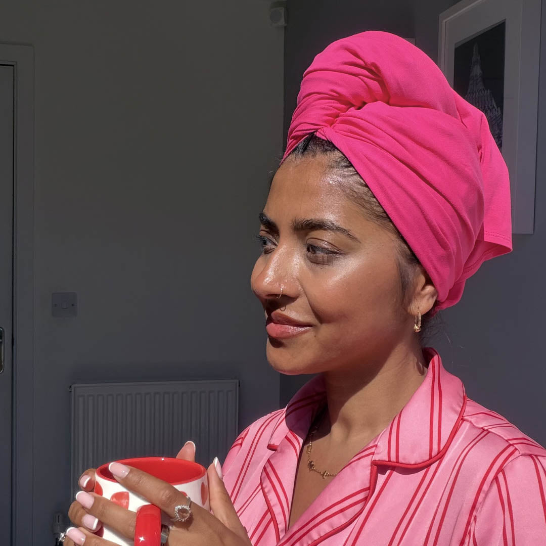 Woman in pyjamas wearing hot pink organic jersey cotton hair towel wrap – Good Wash Day