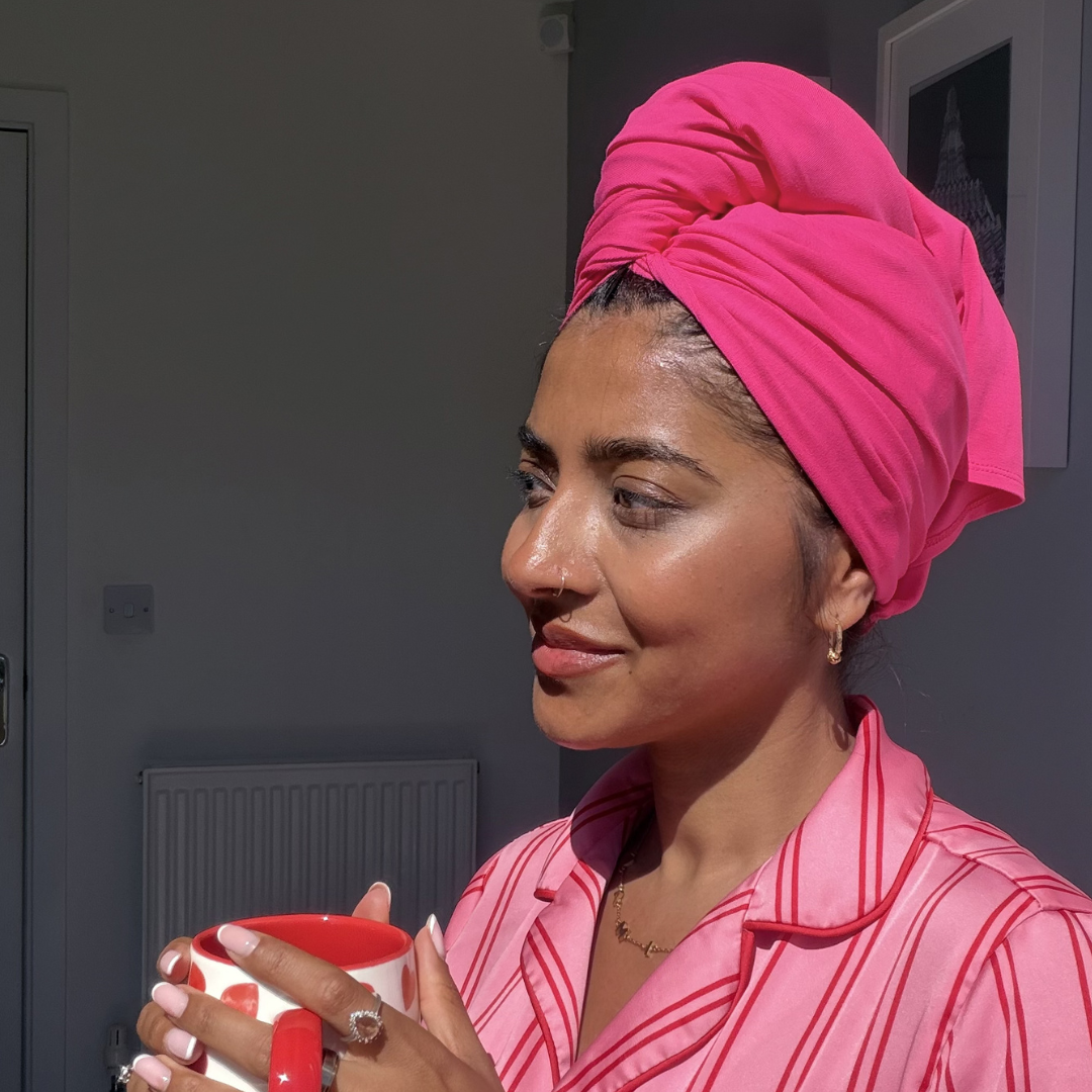 Woman in pyjamas wearing hot pink organic jersey cotton hair towel wrap – Good Wash Day
