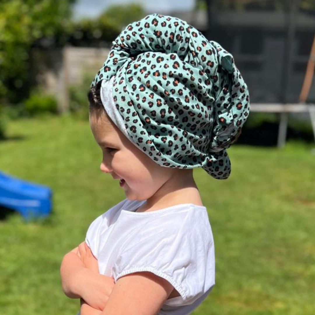 Child wearing mint leopard print organic jersey cotton hair towel wrap – Good Wash Day