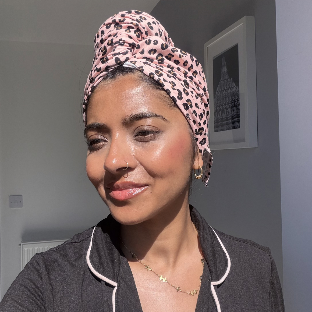 Woman in pyjamas wearing pink animal print organic jersey cotton hair towel wrap – Good Wash Day