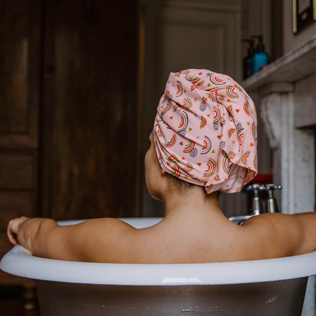 Woman soaking in the bath wearing pink rainbows organic jersey cotton hair towel wrap, currently on sale – Good Wash Day