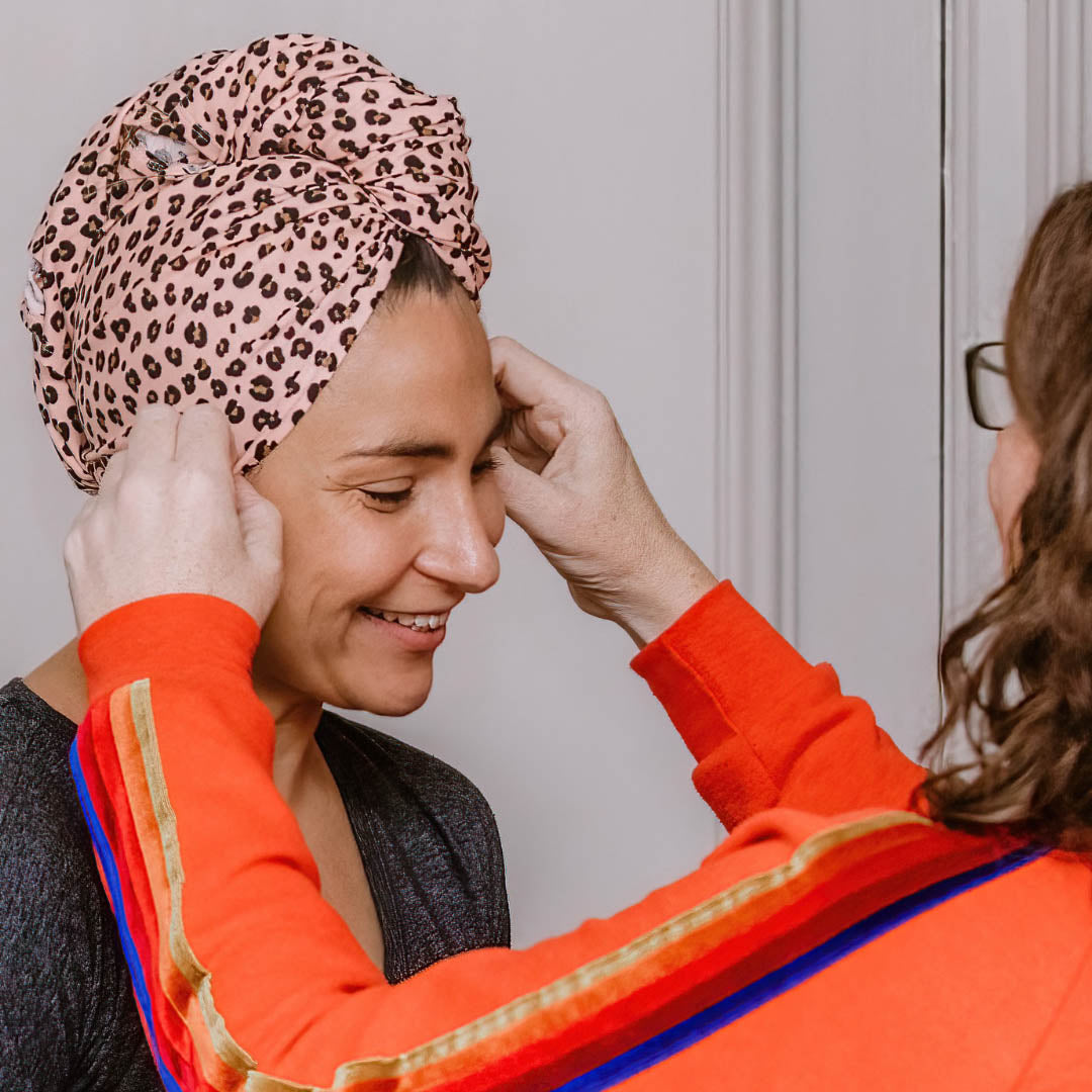 Woman wearing pink leopard print organic jersey cotton hair towel wrap – Good Wash Day
