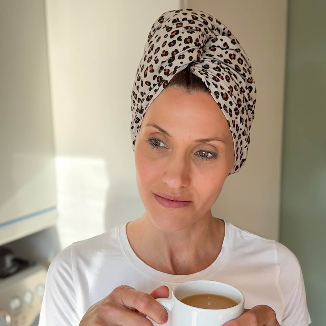 Woman wearing make-up and stone leopard print organic jersey cotton hair towel wrap – Good Wash Day