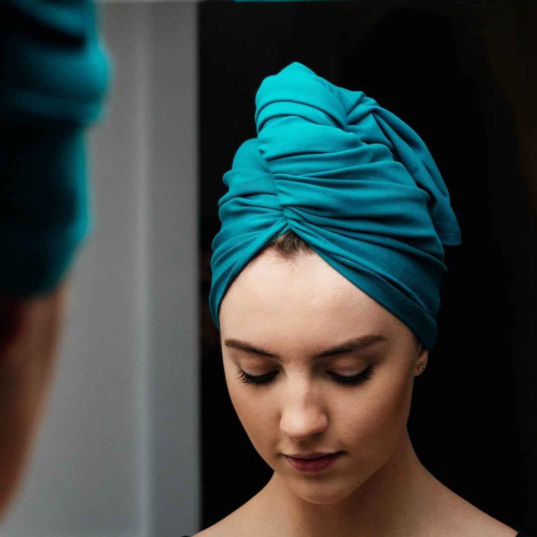 Woman wearing teal XL organic jersey cotton hair towel wrap – Good Wash Day