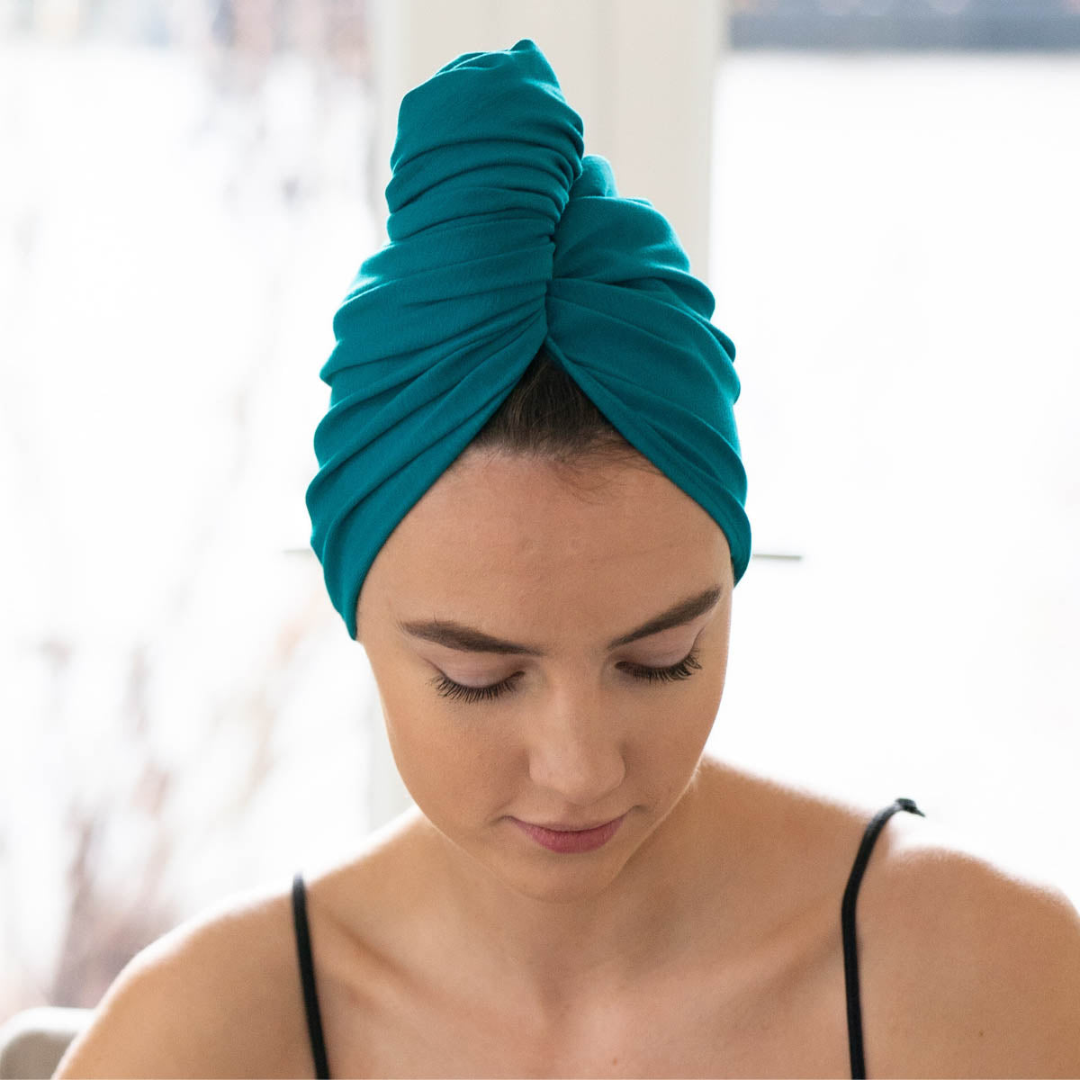 Woman wearing teal organic jersey cotton hair towel wrap – Good Wash Day