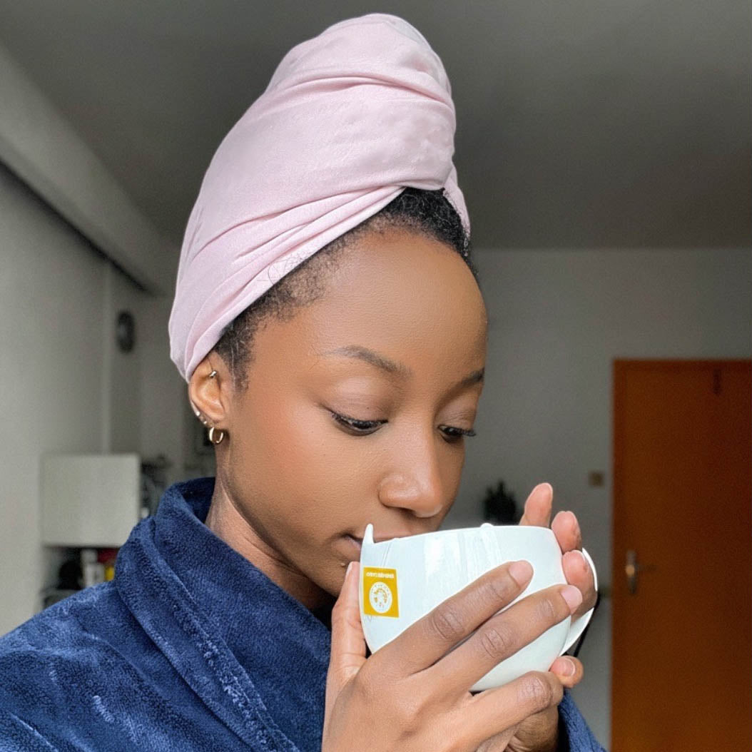 Woman with natural hair wearing blush XL organic jersey cotton hair towel wrap – Good Wash Day