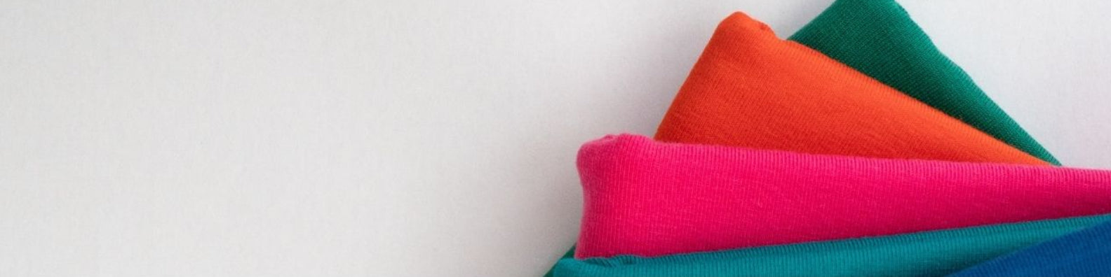 Folded organic jersey cotton hair towels showing 138g weight detail