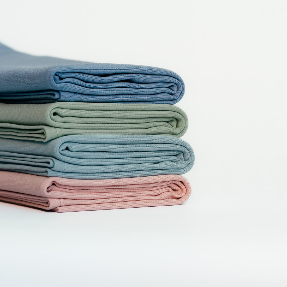 Folded organic jersey cotton hair towels in pastel colours