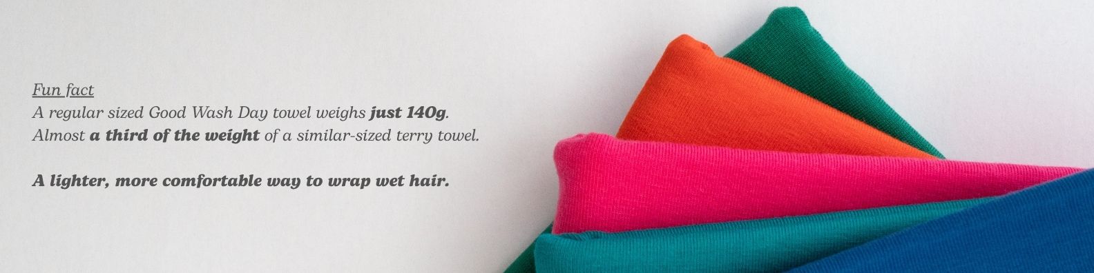 Colourful towels stacked on a white background with text about their lightweight comfort - Good Wash Day